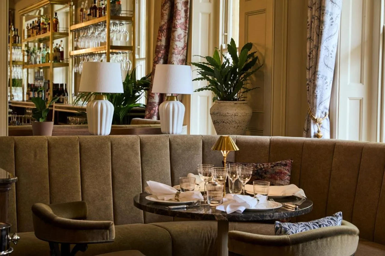 a dining room with a couch and a table at Francis Hotel Bath in Bath